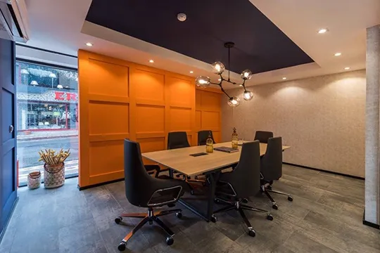 meeting table and chairs in orange meeting room