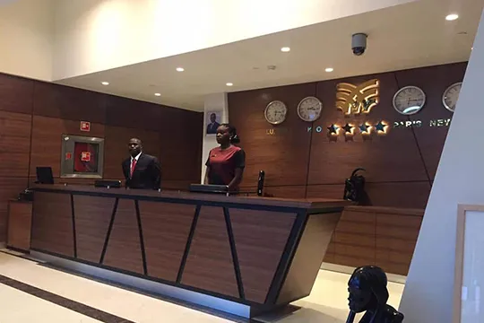 two receptionists behind the counter in the hotel lobby