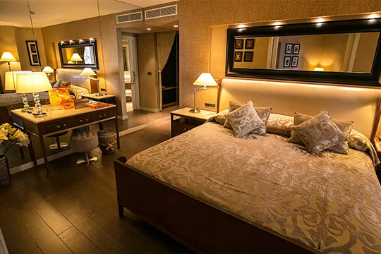 dim lighting of bed and vanity table in hotel room