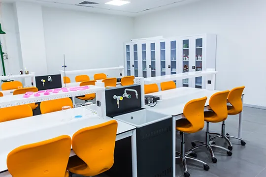 lab tables cabinet and orange student chairs in chemistry lab classroom